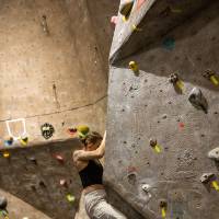 competitor pulling hard on a steep angled climb with small holds